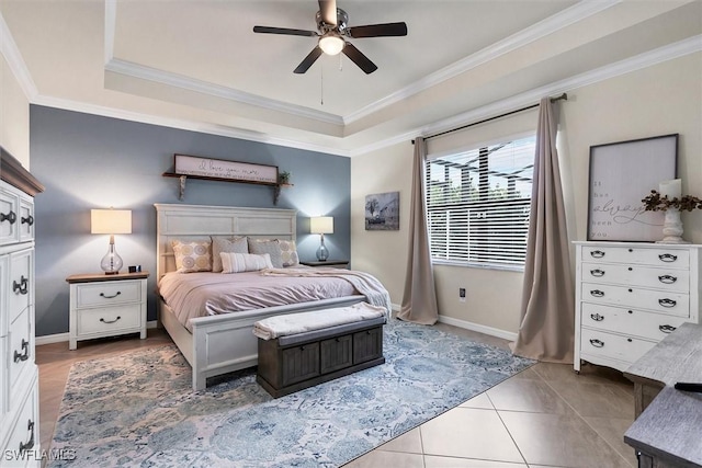 bedroom with a tray ceiling, ornamental molding, ceiling fan, and tile patterned floors