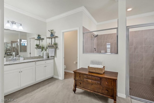 bathroom with toilet, ornamental molding, vanity, a shower with door, and tile patterned flooring