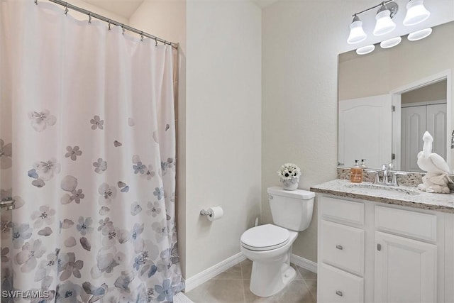 bathroom with vanity, walk in shower, tile patterned floors, and toilet