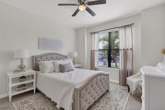 tiled bedroom featuring ceiling fan