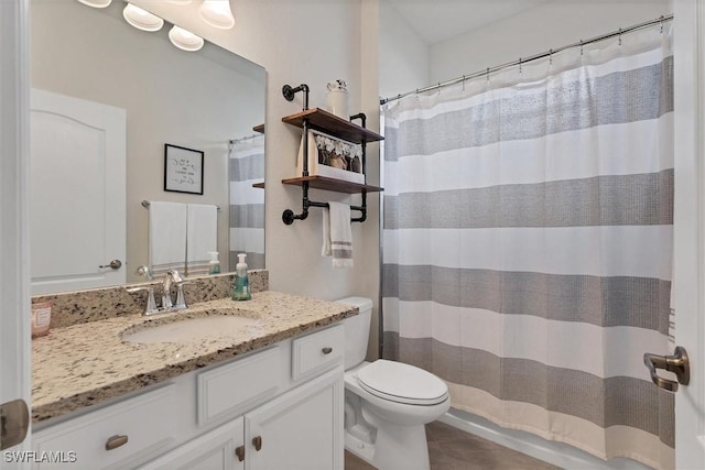 bathroom featuring vanity, toilet, and curtained shower