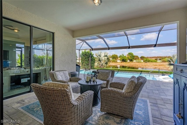 sunroom / solarium with a water view