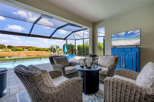 view of patio / terrace with a water view and a lanai