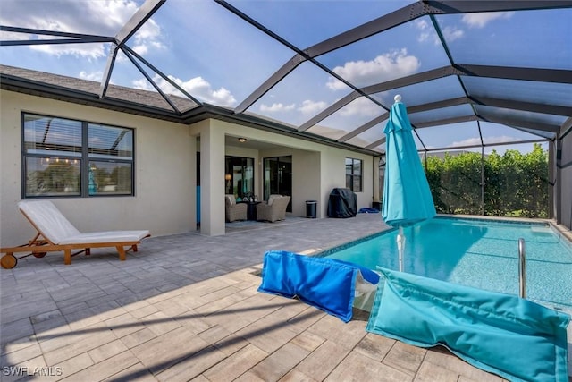 view of pool featuring a lanai, outdoor lounge area, and a patio area