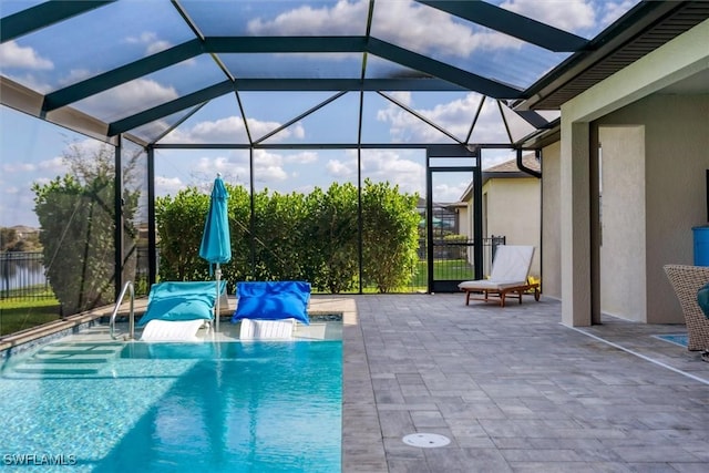 view of swimming pool featuring a patio and glass enclosure