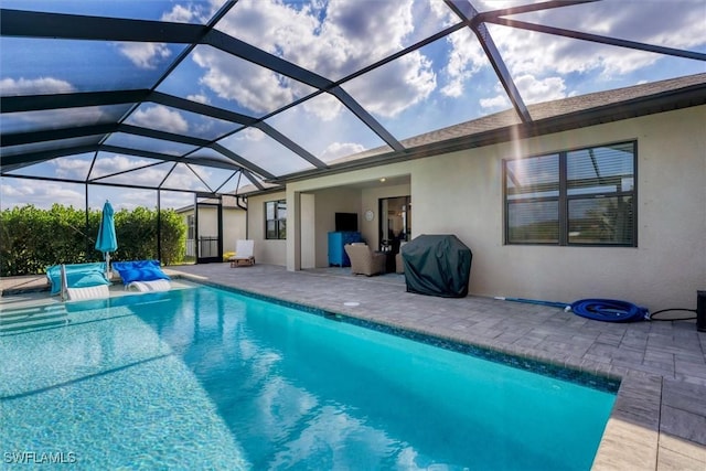 view of pool featuring a grill, a patio area, and glass enclosure