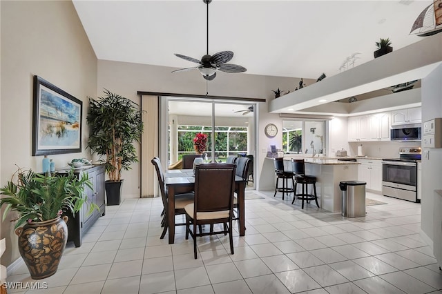 dining area with ceiling fan and light tile patterned floors