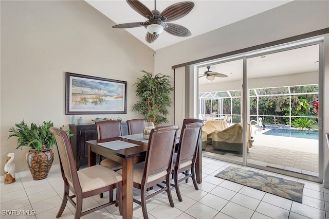 dining room with ceiling fan, a sunroom, vaulted ceiling, and light tile patterned floors