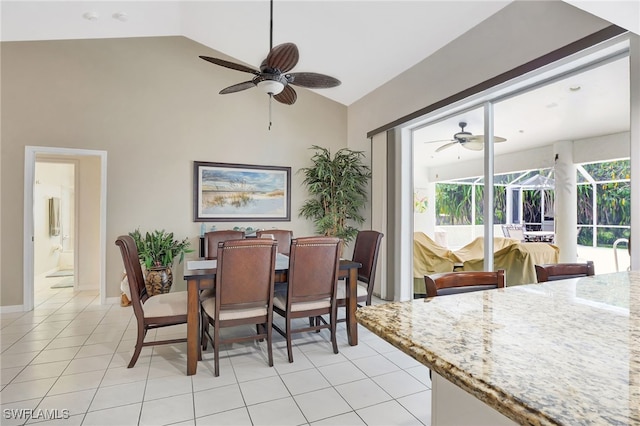 dining area featuring baseboards, a ceiling fan, a sunroom, high vaulted ceiling, and light tile patterned flooring