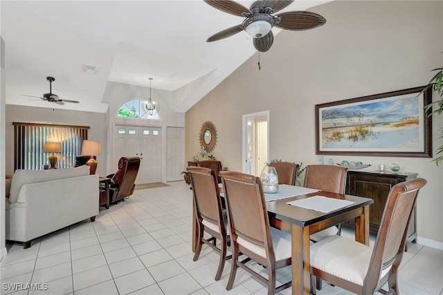 dining space featuring high vaulted ceiling, ceiling fan with notable chandelier, visible vents, and light tile patterned floors