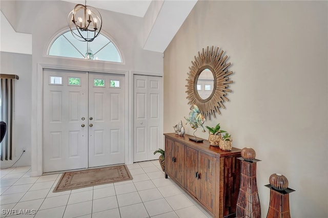 foyer featuring light tile patterned floors and a chandelier