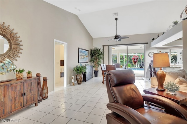 interior space featuring high vaulted ceiling, light tile patterned flooring, visible vents, baseboards, and a ceiling fan