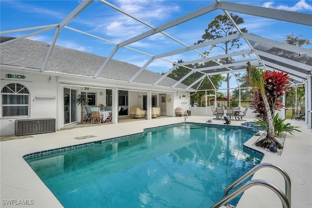 outdoor pool with a lanai, outdoor dining area, and a patio