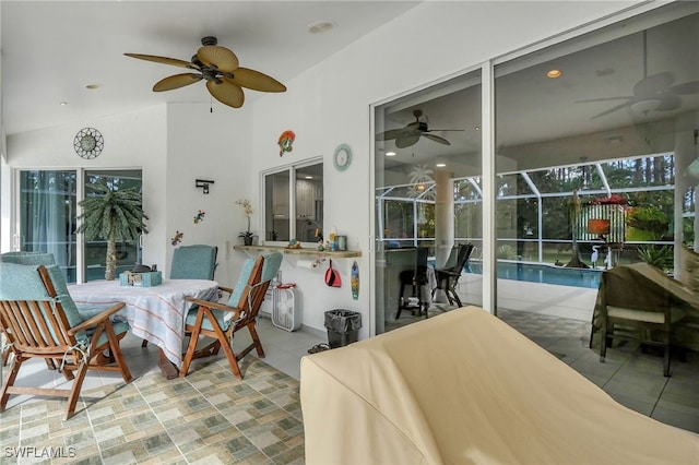 view of patio featuring glass enclosure, an outdoor pool, a ceiling fan, and outdoor dining space