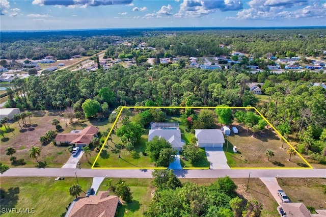 birds eye view of property featuring a wooded view