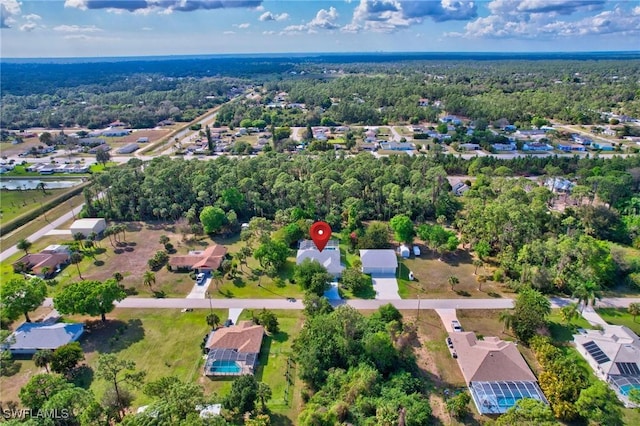 bird's eye view featuring a wooded view and a residential view