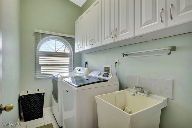 laundry area with light tile patterned floors, a sink, baseboards, cabinet space, and washing machine and clothes dryer