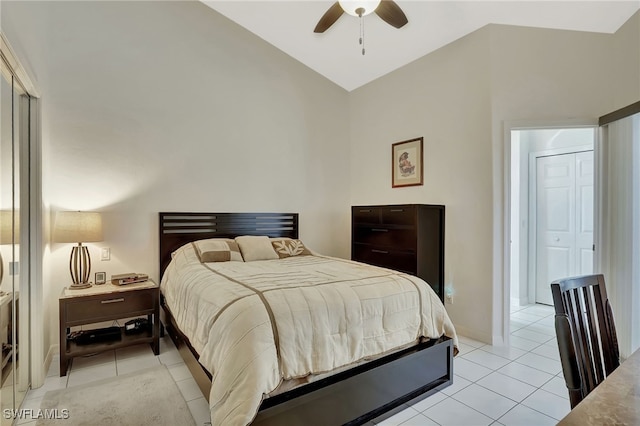 bedroom with light tile patterned floors, ceiling fan, baseboards, and vaulted ceiling