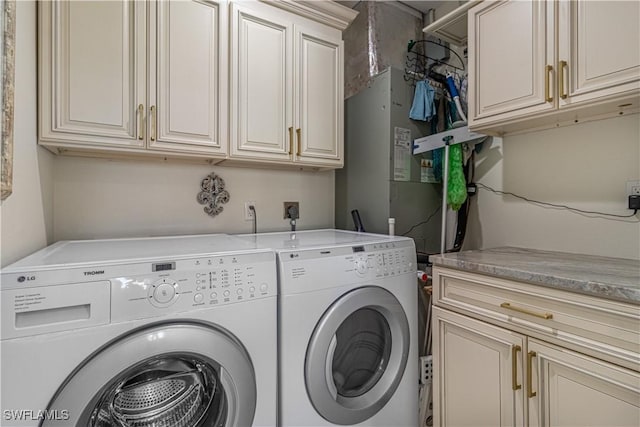 washroom featuring cabinets and separate washer and dryer