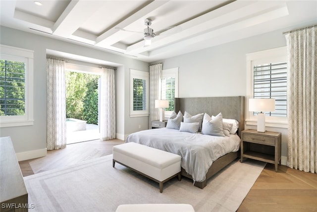 bedroom with access to exterior, a raised ceiling, light parquet flooring, and ceiling fan