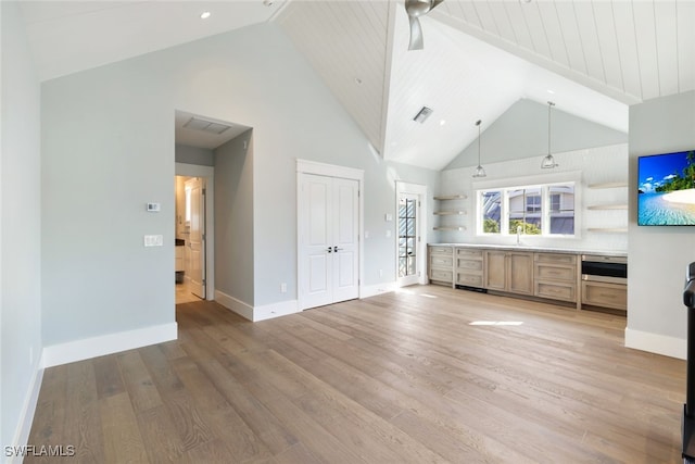 bathroom featuring hardwood / wood-style flooring, sink, and high vaulted ceiling