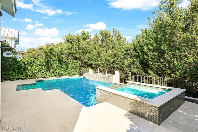 view of pool with an in ground hot tub