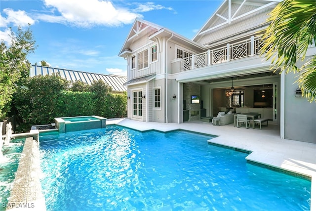 view of pool with an outdoor living space, an in ground hot tub, ceiling fan, and a patio