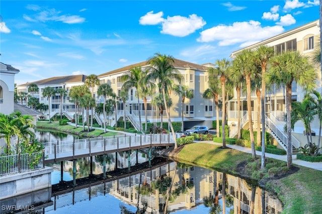 view of building exterior with a water view and stairs