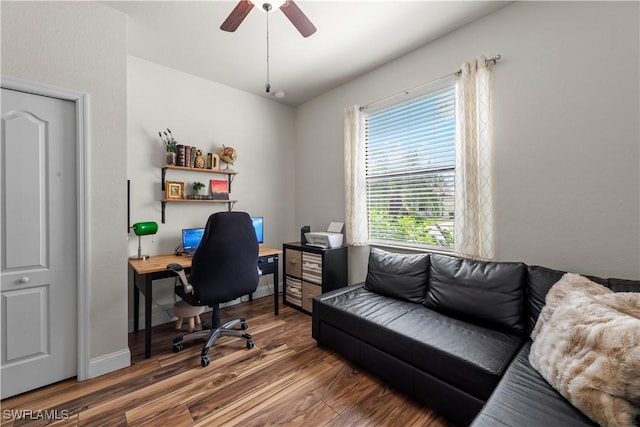 home office with dark wood-type flooring and ceiling fan