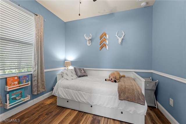 bedroom with dark hardwood / wood-style floors