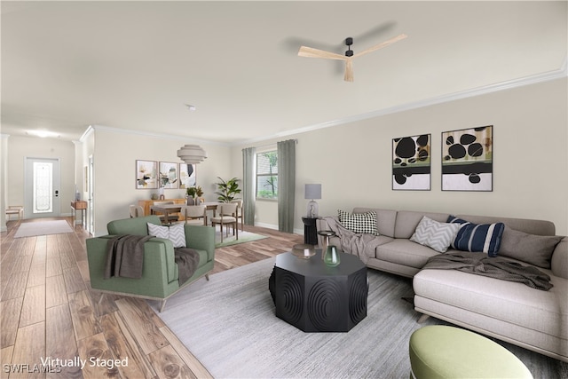 living room featuring crown molding and wood-type flooring