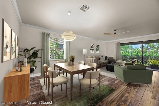 dining area featuring crown molding, ceiling fan, and dark hardwood / wood-style flooring