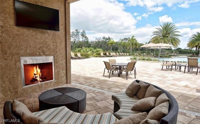 view of patio with a fireplace