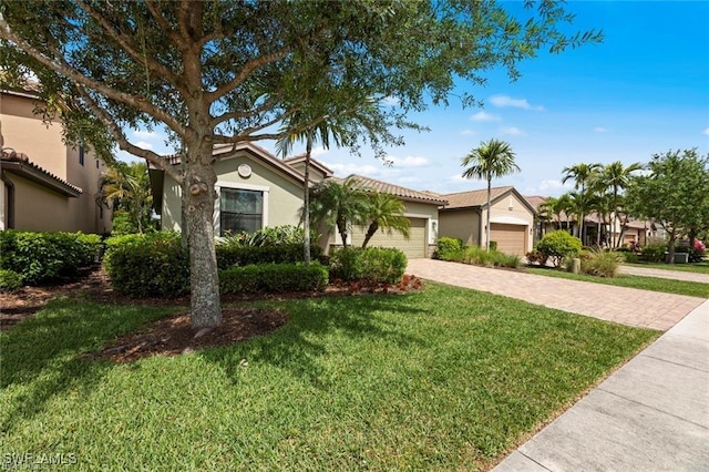 view of front of property featuring a garage and a front yard