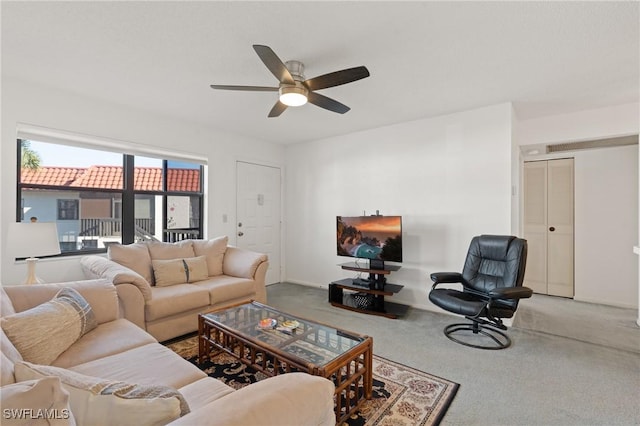 living room featuring carpet and ceiling fan