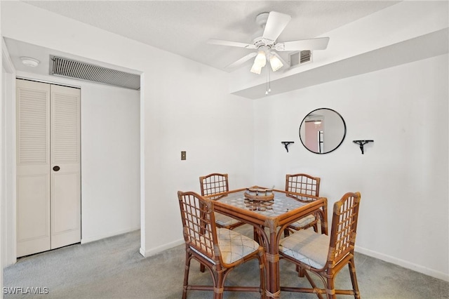 carpeted dining room featuring ceiling fan