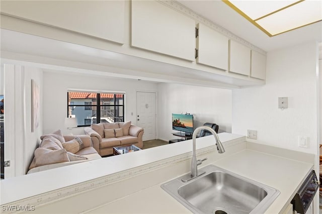 kitchen featuring dishwasher, white cabinetry, and sink