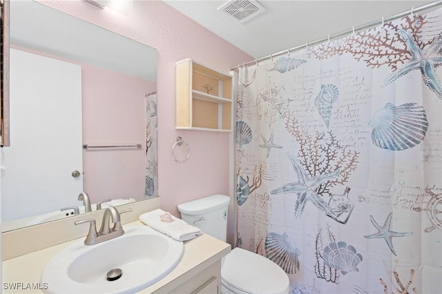 bathroom with a shower with curtain, vanity, and toilet