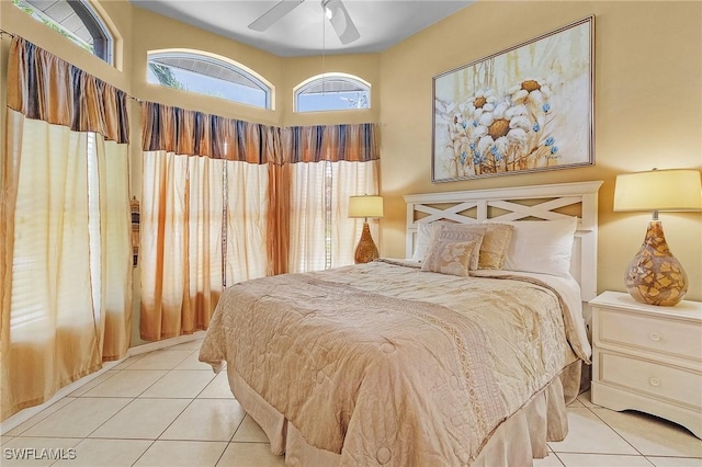 tiled bedroom featuring ceiling fan