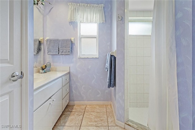 bathroom featuring tiled shower, tile patterned floors, and vanity