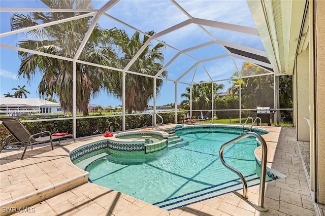 view of pool with an in ground hot tub, glass enclosure, and a patio area