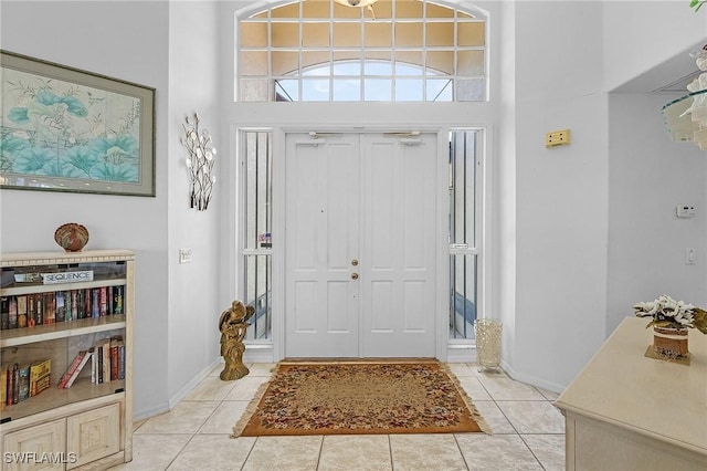 foyer featuring a high ceiling and light tile patterned flooring