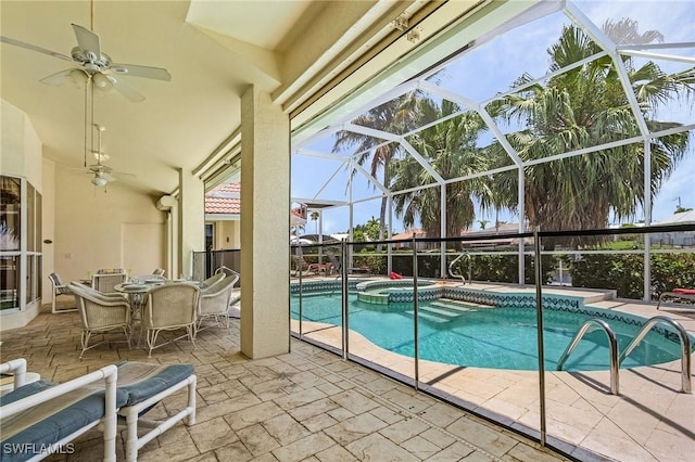 view of pool with an in ground hot tub, ceiling fan, a lanai, and a patio area