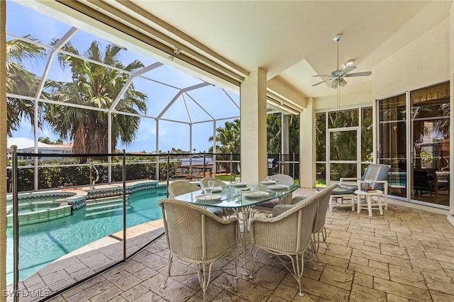 view of swimming pool with an in ground hot tub, ceiling fan, glass enclosure, and a patio area