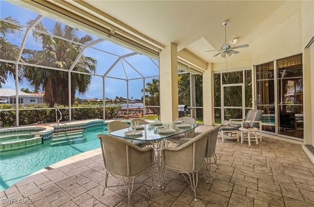 view of swimming pool with an in ground hot tub, ceiling fan, glass enclosure, and a patio