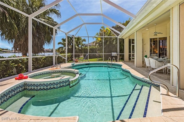 view of pool featuring an in ground hot tub, a patio, ceiling fan, and glass enclosure