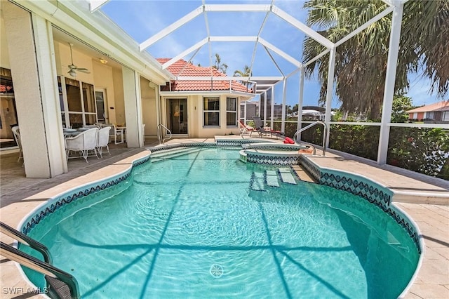 view of swimming pool featuring an in ground hot tub, ceiling fan, a patio, and glass enclosure