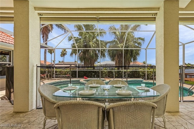 view of patio featuring a jacuzzi and glass enclosure