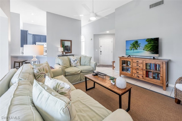 living room with ceiling fan, high vaulted ceiling, and light tile patterned floors