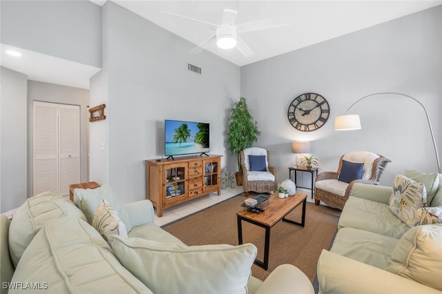 tiled living room with ceiling fan